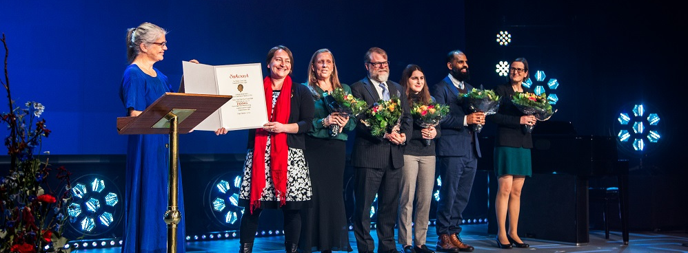 Maria receiving award