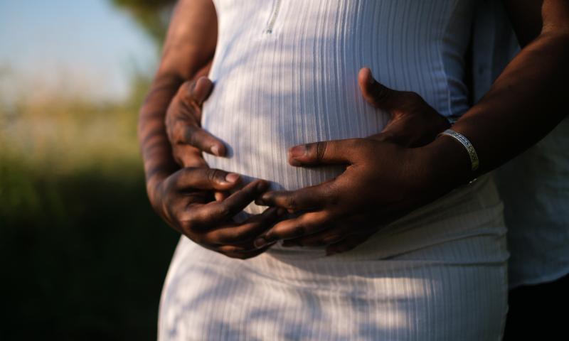 Hands Of A Couple Embracing The Baby Inside Her Growing Belly